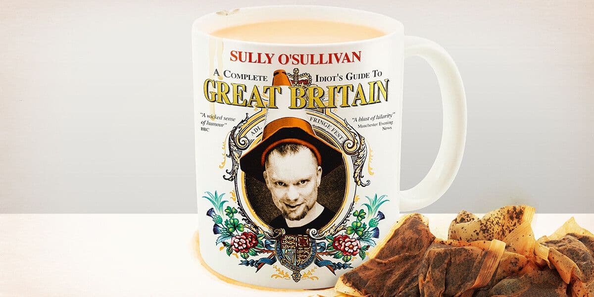A white mug with a floral crest design featuring a sepia-toned image of comedian Sully O’Sullivan wearing a traffic cone as a crown; tea drips from the chipped rim of the mug, and to the right is a pile of used teabags. Emblazoned on the mug are the words ‘A Complete Idiot’s Guide to Great Britain’, and the quotes "A wicked sense of humour" BBC, and 'A Blast of Hilarity' Manchester Evening News.
